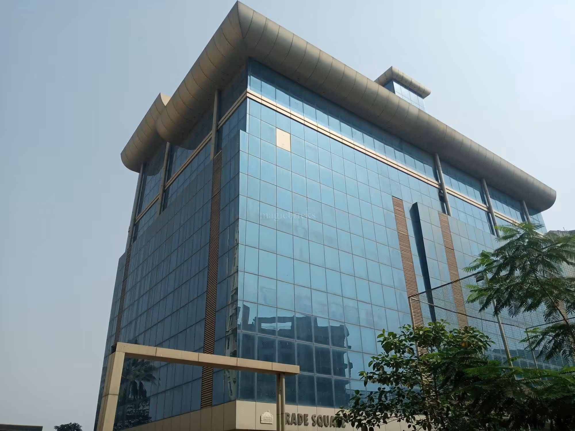 Upward view of the Trade Square glass facade and its curved metal cornice